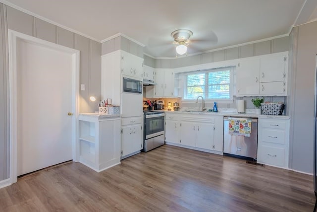 kitchen with stainless steel appliances, light wood-type flooring, and white cabinets