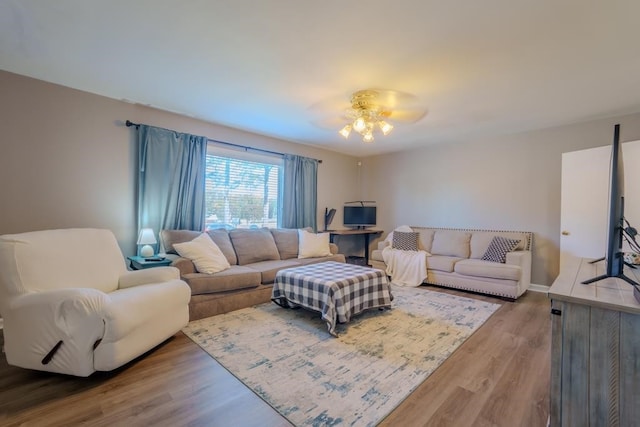 living room with hardwood / wood-style flooring and ceiling fan