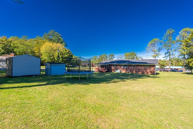 view of yard featuring a storage unit and a trampoline