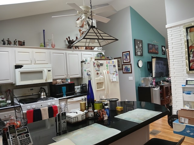 kitchen featuring white appliances, ceiling fan, wood-type flooring, and white cabinets