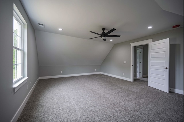 bonus room featuring lofted ceiling, a healthy amount of sunlight, carpet, and ceiling fan