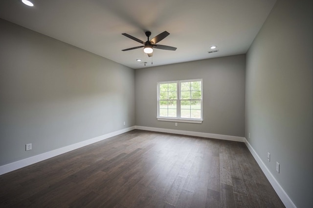 spare room with dark hardwood / wood-style floors and ceiling fan