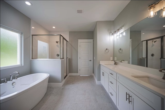 bathroom featuring vanity, shower with separate bathtub, and tile patterned flooring