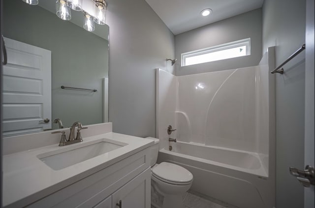 full bathroom featuring toilet, vanity, and tub / shower combination