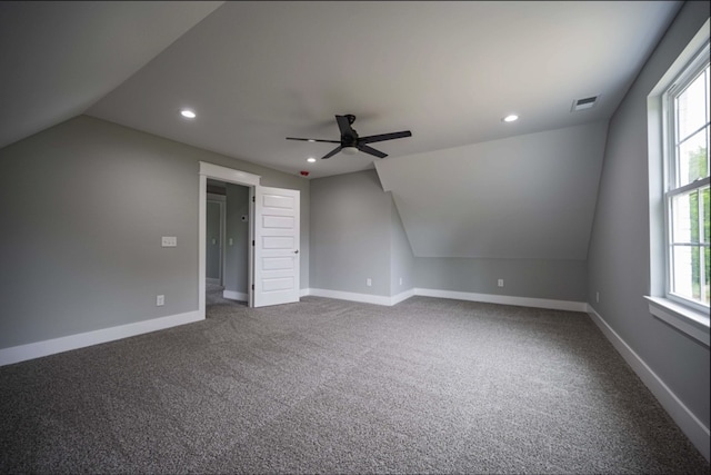 interior space with ceiling fan, carpet, and lofted ceiling