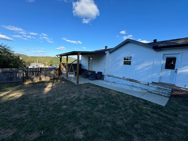 back of property featuring a patio and a lawn