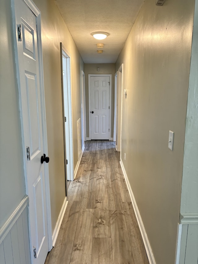 corridor featuring light hardwood / wood-style floors