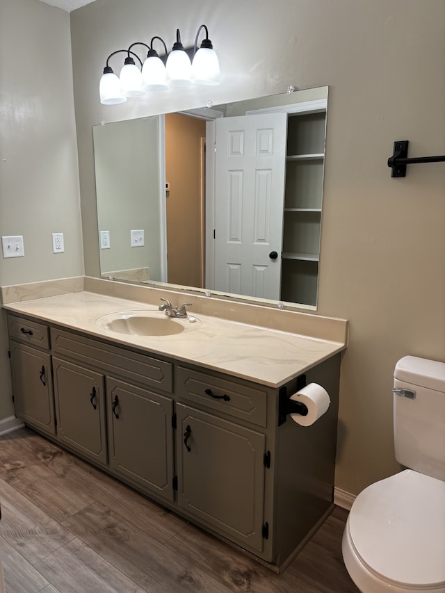 bathroom featuring vanity, toilet, and hardwood / wood-style flooring