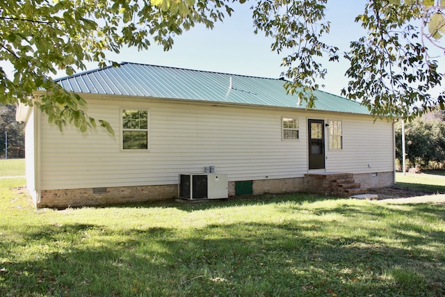 back of house with a yard and cooling unit