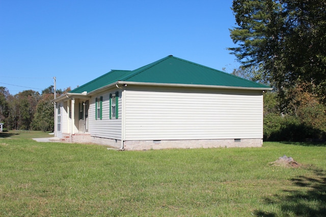 view of side of home with a lawn