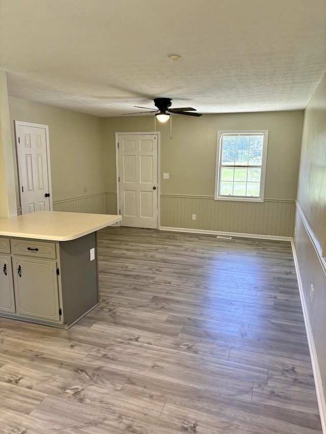 kitchen featuring a textured ceiling, light wood-type flooring, and ceiling fan