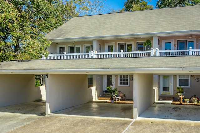 view of front facade with a balcony and a carport