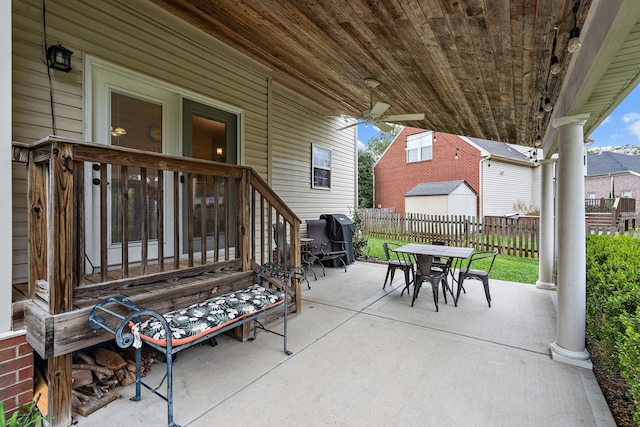 view of patio / terrace featuring area for grilling, ceiling fan, and a storage unit