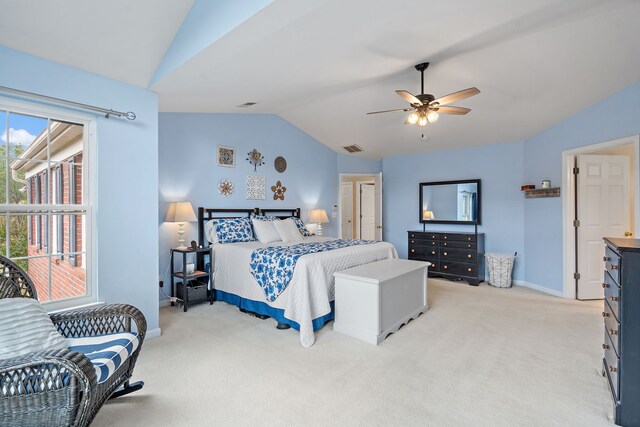 bedroom with ceiling fan, lofted ceiling, and light colored carpet