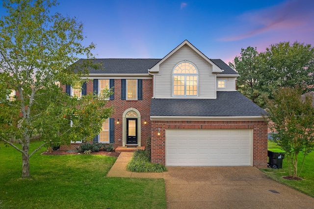 view of front facade with a yard and a garage