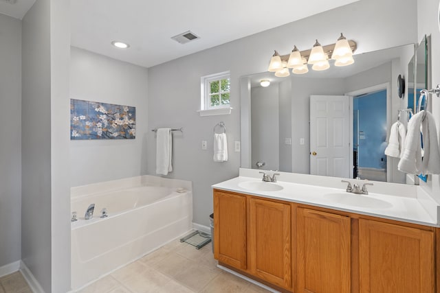 bathroom with vanity, a tub to relax in, and tile patterned floors