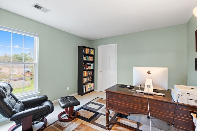 office space with a healthy amount of sunlight and light colored carpet