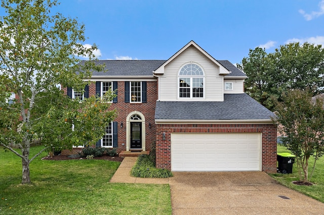 view of front of property with a front lawn and a garage