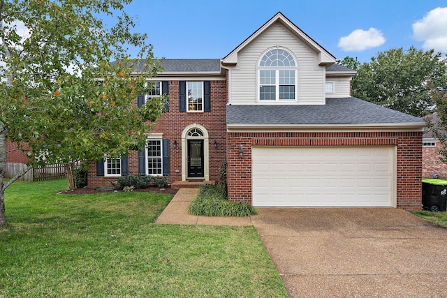 view of front of property featuring a front yard and a garage