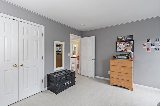 bedroom featuring light colored carpet and a closet