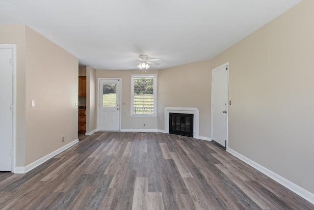 unfurnished living room with hardwood / wood-style floors and ceiling fan