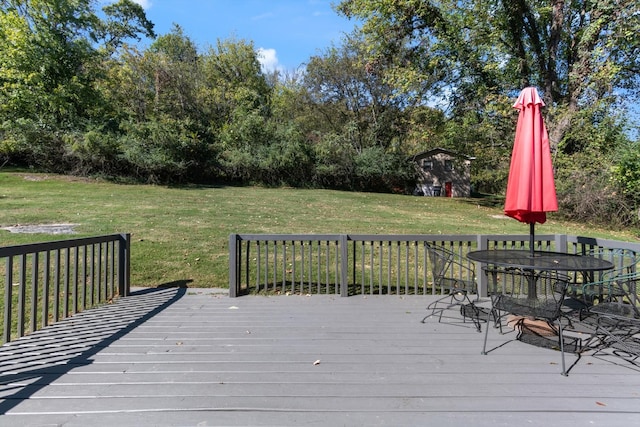 wooden terrace featuring a yard