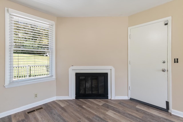 unfurnished living room with hardwood / wood-style flooring