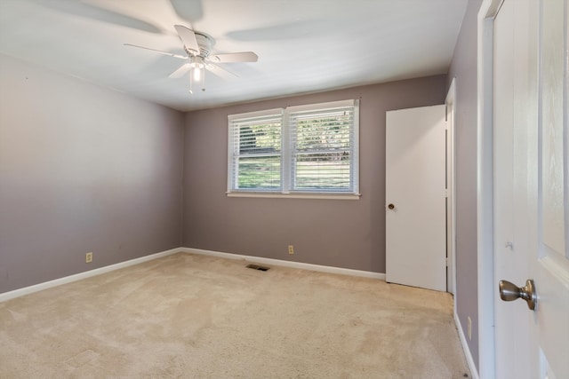 empty room featuring light carpet and ceiling fan