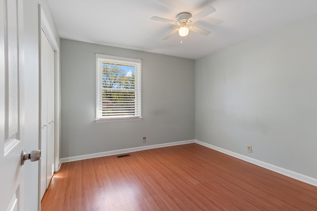 unfurnished bedroom with light hardwood / wood-style flooring, a closet, and ceiling fan