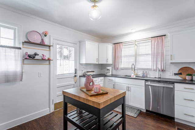 kitchen with white cabinets, stainless steel dishwasher, sink, and backsplash