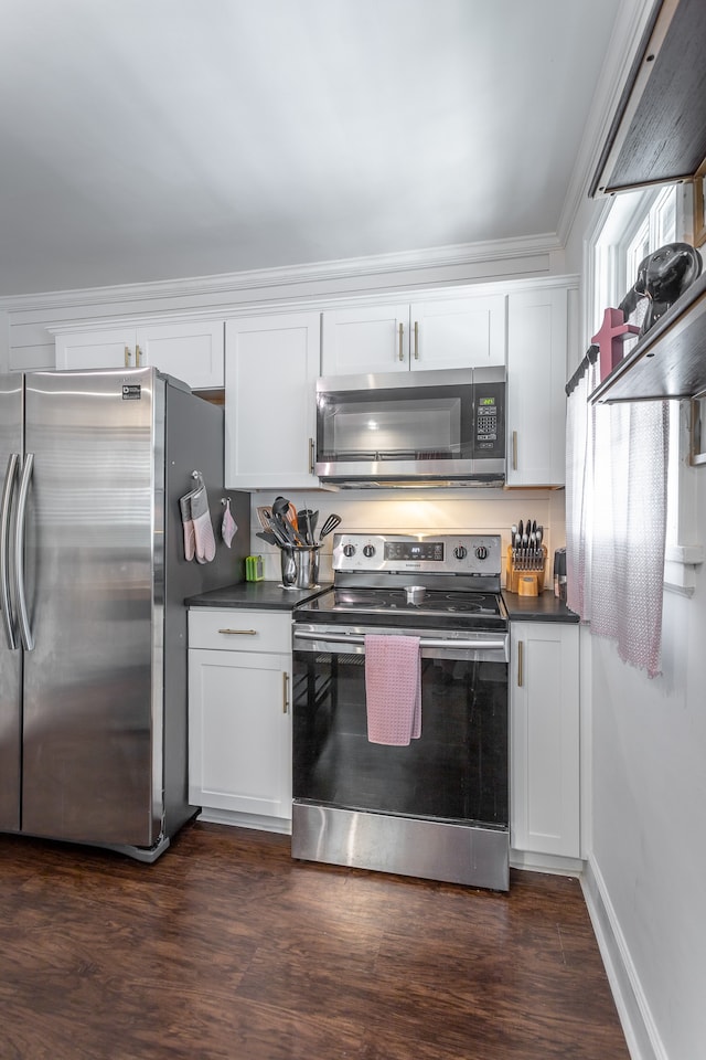 kitchen featuring ornamental molding, appliances with stainless steel finishes, dark hardwood / wood-style floors, and white cabinetry