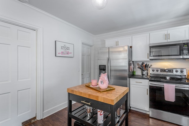 kitchen featuring white cabinetry, appliances with stainless steel finishes, ornamental molding, and dark wood-type flooring