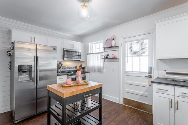 kitchen featuring dark wood-type flooring, stainless steel appliances, decorative backsplash, and white cabinets