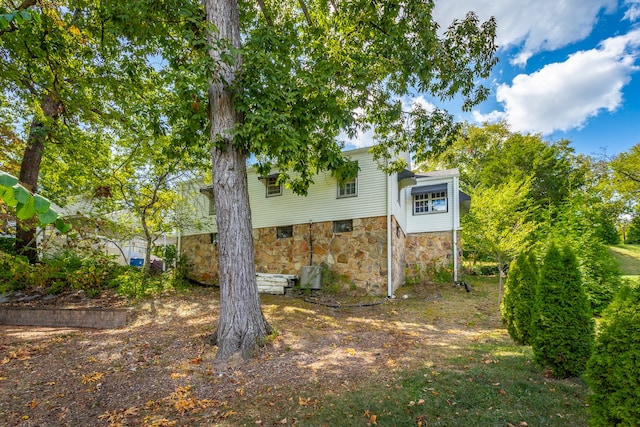 rear view of property featuring cooling unit