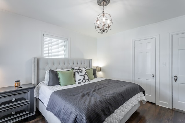 bedroom featuring dark hardwood / wood-style floors and an inviting chandelier