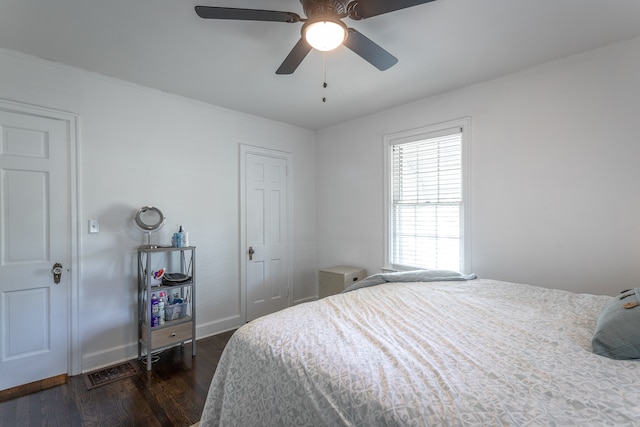 bedroom with dark wood-type flooring and ceiling fan