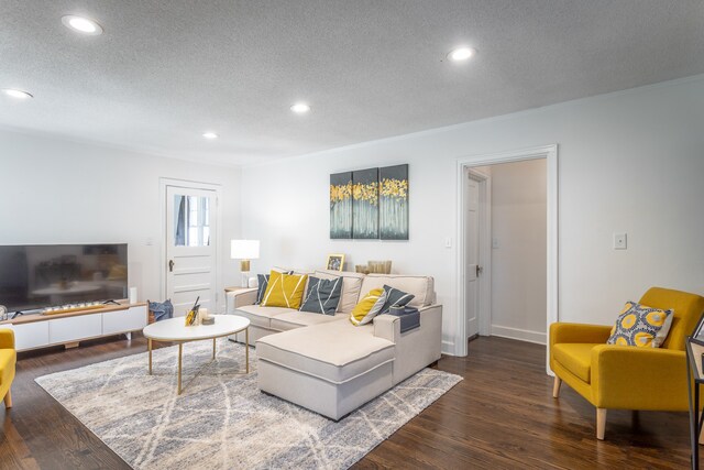 living room featuring a textured ceiling and dark hardwood / wood-style floors