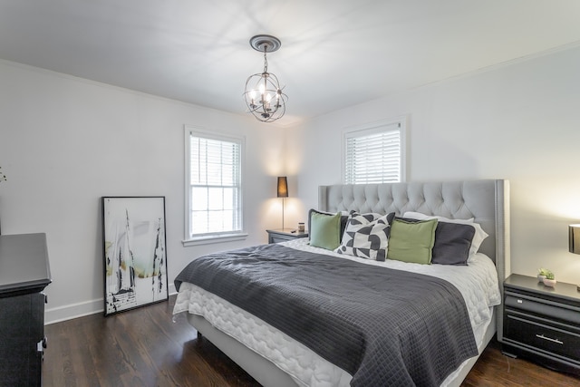 bedroom featuring crown molding, a notable chandelier, multiple windows, and dark hardwood / wood-style floors