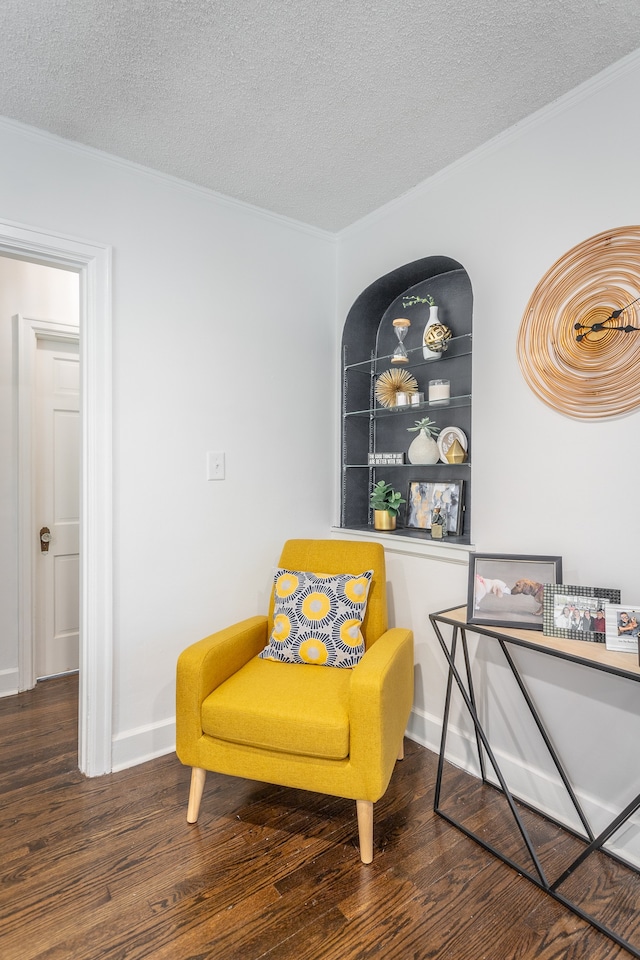 sitting room with a textured ceiling and dark wood-type flooring