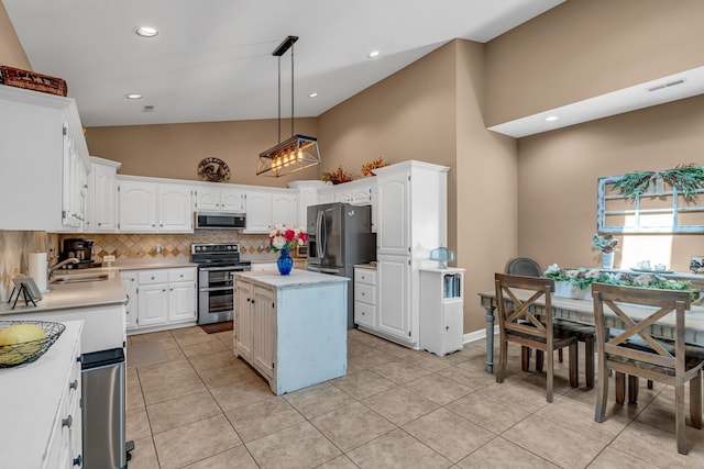 kitchen with hanging light fixtures, appliances with stainless steel finishes, white cabinetry, sink, and a center island