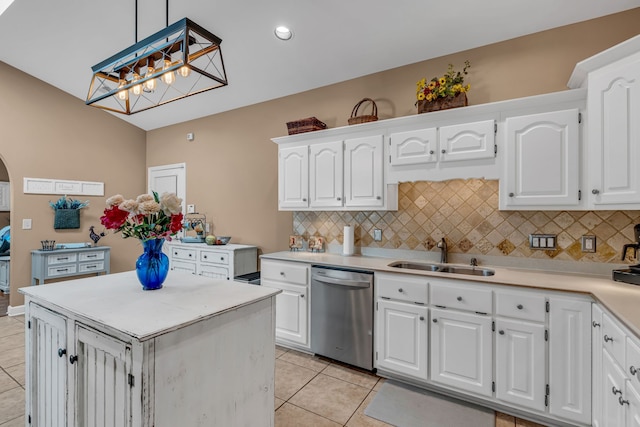 kitchen with white cabinets, stainless steel dishwasher, sink, and decorative light fixtures