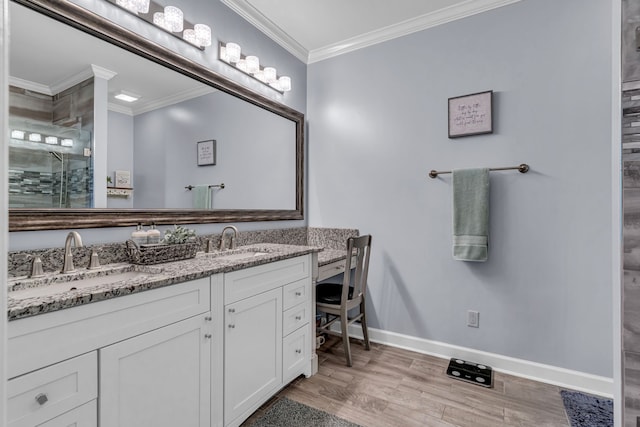 bathroom with vanity, crown molding, a shower with shower door, and hardwood / wood-style floors