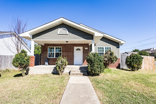 bungalow-style house with a front lawn