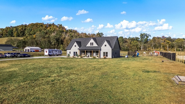 view of front facade with a front lawn and fence