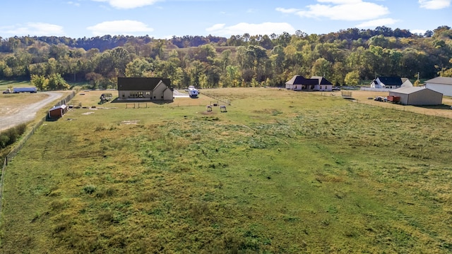 bird's eye view with a view of trees and a rural view