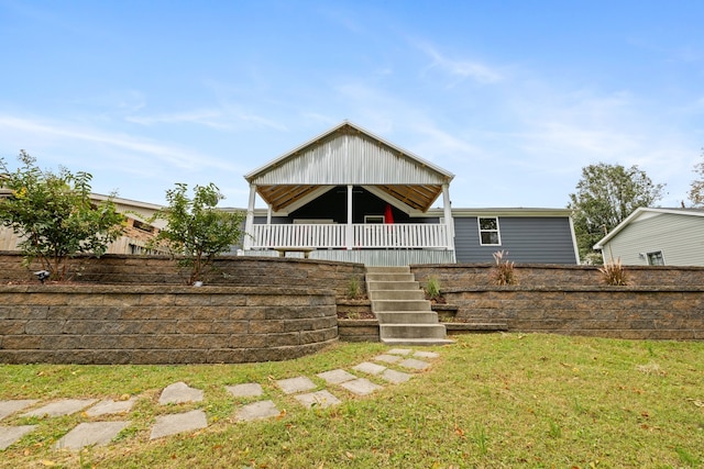 back of property featuring a lawn