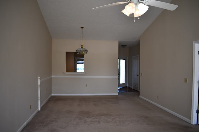 spare room with lofted ceiling, carpet floors, and ceiling fan with notable chandelier