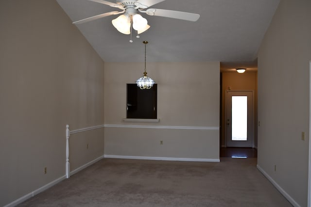 unfurnished room with carpet flooring, vaulted ceiling, and ceiling fan