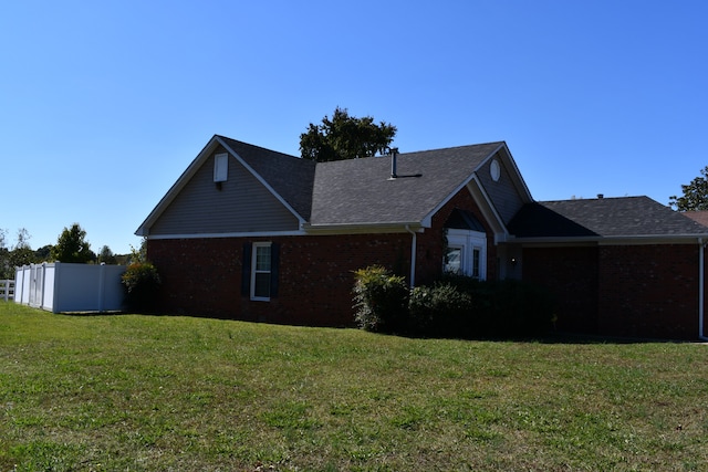 view of side of home featuring a lawn