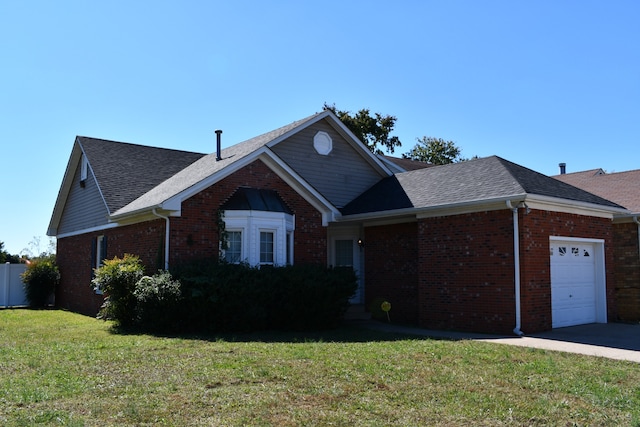 view of front of house with a front yard and a garage